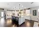 Modern kitchen featuring a large island with seating, stainless steel appliances, and ample cabinet space at 7855 Sw 97Th Cir, Ocala, FL 34481
