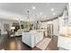 Open-concept kitchen featuring a large island, stainless steel appliances, and a seamless flow to the living area at 7855 Sw 97Th Cir, Ocala, FL 34481