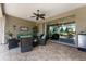 Relaxing lanai with comfortable seating, a ceiling fan, and views of the lush backyard and interior at 7855 Sw 97Th Cir, Ocala, FL 34481