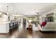 Bright and spacious living space with dark wood floors, a large kitchen island, and comfortable seating area at 7855 Sw 97Th Cir, Ocala, FL 34481