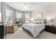 Bright main bedroom with great natural light, complemented by a sitting area, and neutral color palette at 7855 Sw 97Th Cir, Ocala, FL 34481