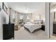 Well-lit main bedroom featuring a seating area, office desk, and ensuite bathroom at 7855 Sw 97Th Cir, Ocala, FL 34481