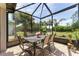 Covered lanai features a dining table with seating for outdoor gatherings at 7855 Sw 97Th Cir, Ocala, FL 34481