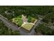 An aerial view showcases this home surrounded by lush landscaping and mature trees on a sprawling lot at 8221 Sw 217 Ct, Dunnellon, FL 34431
