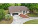 Aerial view of a one-story home with neutral paint, attached garage, and a circular driveway at 8221 Sw 217 Ct, Dunnellon, FL 34431