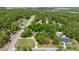 Aerial view of a charming home on a large lot surrounded by lush trees and a circular driveway at 8221 Sw 217 Ct, Dunnellon, FL 34431