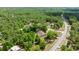 An aerial view of a cozy home nestled among lush trees with a long driveway at 8221 Sw 217 Ct, Dunnellon, FL 34431