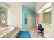 Bright bathroom featuring a soaking tub, and a built in vanity area, and tiled floors at 8221 Sw 217 Ct, Dunnellon, FL 34431