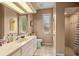 Bright bathroom featuring a large vanity with white cabinets, a neutral color scheme and a walk-in shower at 8221 Sw 217 Ct, Dunnellon, FL 34431
