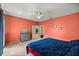 Cozy bedroom featuring carpet flooring, ceiling fan, and a comfortable queen-sized bed at 8221 Sw 217 Ct, Dunnellon, FL 34431