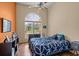 Comfortable bedroom featuring hardwood floors, a ceiling fan, and a window with a backyard view at 8221 Sw 217 Ct, Dunnellon, FL 34431