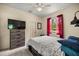 Relaxing bedroom with a dresser, ceiling fan, natural light, and a comfortable queen-sized bed at 8221 Sw 217 Ct, Dunnellon, FL 34431