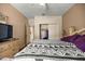 Comfortable bedroom with neutral walls, a ceiling fan, and a door to the closet on the back wall at 8221 Sw 217 Ct, Dunnellon, FL 34431