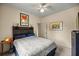 Modern bedroom featuring creative decor, wall art, a ceiling fan, and a comfortable queen-sized bed at 8221 Sw 217 Ct, Dunnellon, FL 34431