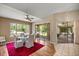 Bright breakfast area with a modern glass table, chairs, and views of the yard at 8221 Sw 217 Ct, Dunnellon, FL 34431
