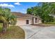 Single Gathering home with an attached two car garage and mature trees and landscaping at 8221 Sw 217 Ct, Dunnellon, FL 34431