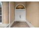 Inviting entryway with double doors, arched transom window, and welcome mat at 8221 Sw 217 Ct, Dunnellon, FL 34431