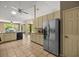 A spacious kitchen with stainless steel refrigerator and abundant cabinet space at 8221 Sw 217 Ct, Dunnellon, FL 34431
