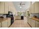 Well-lit kitchen with ample counter space, light-colored cabinets, and black appliances at 8221 Sw 217 Ct, Dunnellon, FL 34431