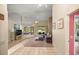 Spacious living room with tile floors, a fan, a comfortable blue sofa, and plenty of natural light at 8221 Sw 217 Ct, Dunnellon, FL 34431