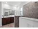 Bathroom featuring double sinks, quartz countertops, wood cabinets and a walk-in shower at 8546 Sw 79Th Ave, Ocala, FL 34476