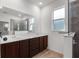 Bathroom featuring double sinks, quartz countertops, wood cabinets and a walk-in shower at 8546 Sw 79Th Ave, Ocala, FL 34476