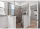 Modern bathroom featuring tiled walk-in shower with glass enclosure and shower niche at 8546 Sw 79Th Ave, Ocala, FL 34476