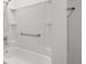 Bright bathroom featuring a white tub and grab bar for accessibility at 8546 Sw 79Th Ave, Ocala, FL 34476