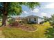 A beautifully landscaped backyard featuring a well-maintained lawn and attractive garden beds around the house at 8546 Sw 79Th Ave, Ocala, FL 34476