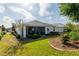 Well-manicured backyard with lush landscaping, screen porch and curb edging with green lawn at 8546 Sw 79Th Ave, Ocala, FL 34476