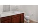 Modern bathroom features a wood vanity, quartz countertop, updated fixtures and a shower with a white surround at 8546 Sw 79Th Ave, Ocala, FL 34476