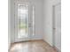 Bright foyer featuring a decorative glass front door, neutral tile flooring, and a coat closet at 8546 Sw 79Th Ave, Ocala, FL 34476