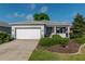 Single-story home with a two-car garage, gray exterior paint, and manicured landscaping at 8546 Sw 79Th Ave, Ocala, FL 34476