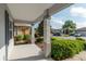Spacious covered front porch with gray support columns and landscaping at 8546 Sw 79Th Ave, Ocala, FL 34476