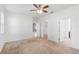 A spacious main bedroom featuring neutral carpet, a ceiling fan, and multiple closets for ample storage at 8546 Sw 79Th Ave, Ocala, FL 34476