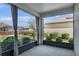 Enclosed patio with concrete flooring offering a view of the manicured lawn and landscaping at 8546 Sw 79Th Ave, Ocala, FL 34476