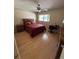 Bright bedroom with hardwood floors, ceiling fan, and natural lighting at 8680 Sw 94Th St # D, Ocala, FL 34481