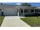 Charming single-story home with a well-maintained front yard and a covered porch at 8680 Sw 94Th St # D, Ocala, FL 34481