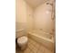 Bright bathroom featuring a standard bathtub and shower combination with neutral-toned tiling at 8683 Sw 62Nd Ct, Ocala, FL 34476