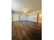 Spacious bedroom features wood-look flooring, ceiling fan, and ensuite bathroom at 8683 Sw 62Nd Ct, Ocala, FL 34476