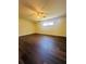 Bright bedroom featuring wood-look floors and natural light from a window at 8683 Sw 62Nd Ct, Ocala, FL 34476