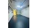 Spacious garage with epoxy flooring, shelving, and door to the house at 8683 Sw 62Nd Ct, Ocala, FL 34476