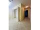 Tiled hallway with closet with shelving, and entry way to garage at 8683 Sw 62Nd Ct, Ocala, FL 34476