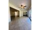 Open living room with tiled floors, ceiling fan, and sliding glass doors leading to the outside at 8683 Sw 62Nd Ct, Ocala, FL 34476