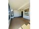 Covered porch with concrete flooring and storm door, entry door, and side window at 8683 Sw 62Nd Ct, Ocala, FL 34476