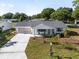 Aerial shot of the home showcasing its well-manicured lawn, screen garage, and curb appeal at 8851 Sw 116Th Street Rd, Ocala, FL 34481