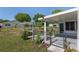 Back patio leads to a fenced yard, complete with a trellis and a screened-in lanai at 8851 Sw 116Th Street Rd, Ocala, FL 34481