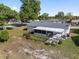 Image displays a home's backyard with a screened patio, fenced-in space, and mature trees providing ample shade at 8851 Sw 116Th Street Rd, Ocala, FL 34481