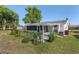 The fenced backyard includes a screened-in lanai and a decorative trellis at 8851 Sw 116Th Street Rd, Ocala, FL 34481
