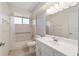 Bright bathroom with white vanity, tile floors, and a shower-tub combination with safety bars at 8851 Sw 116Th Street Rd, Ocala, FL 34481